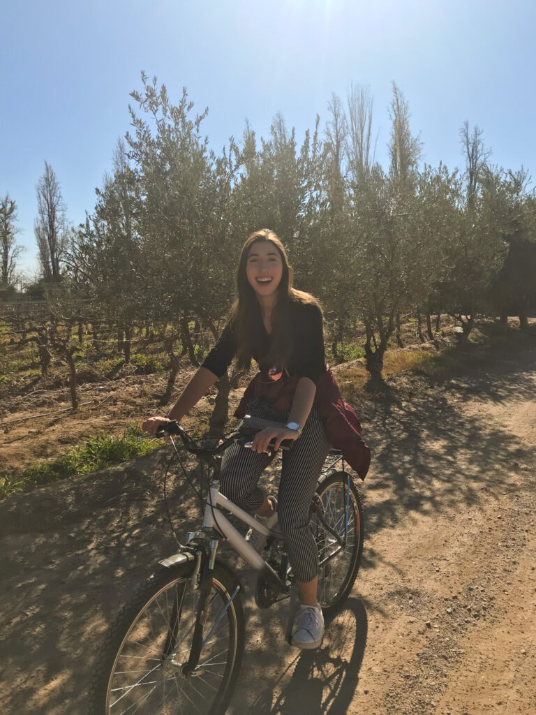 Girl on a bike in a vineyard