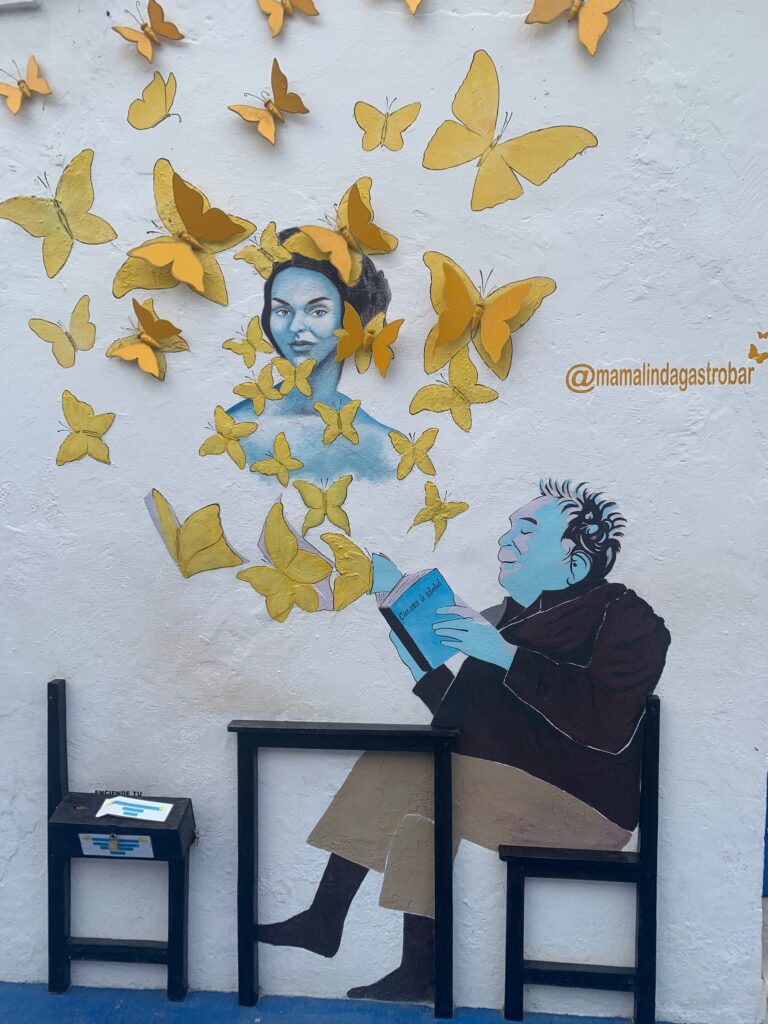 Street Art of Man Reading a Book with Yellow Butterflies