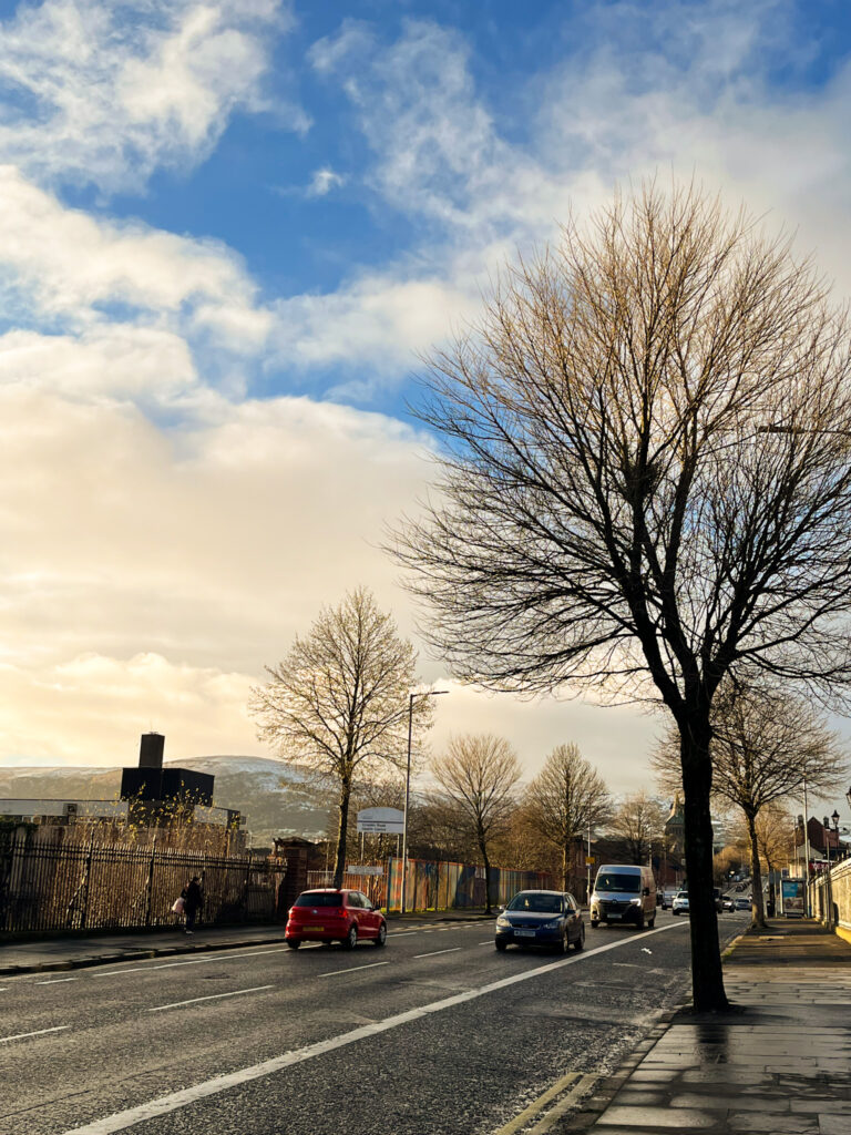 Street in Belfast, with mountains visible in the background
