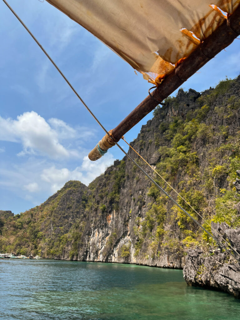 Coron limestone cliffs and a boat mast
