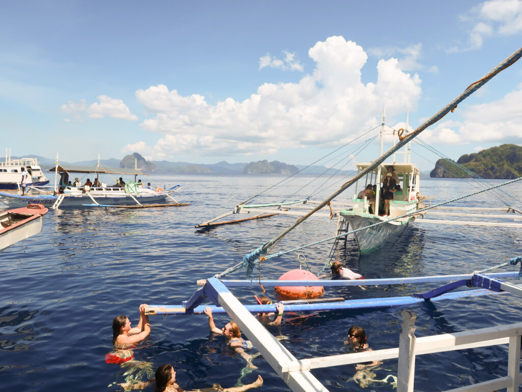 Group of travelers swimming in El Nido water