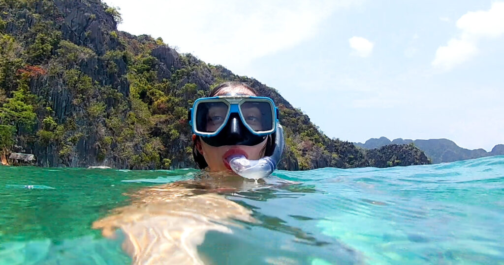 Girl going snorkeling in Coron ocean