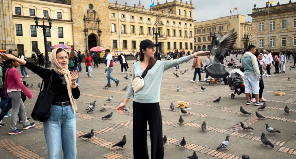 Two Women Holding Pigeons in Plaza de Bolívar